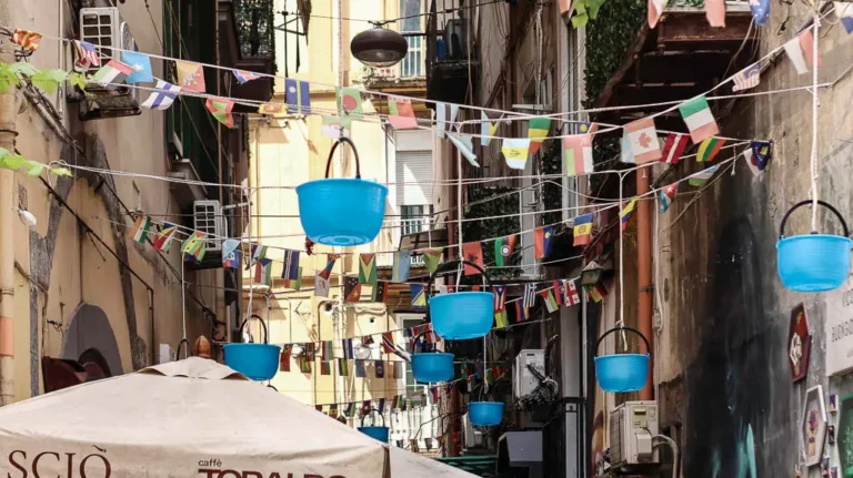 A cute alley with baskets hanging from the balconies in Naples Sanita District
