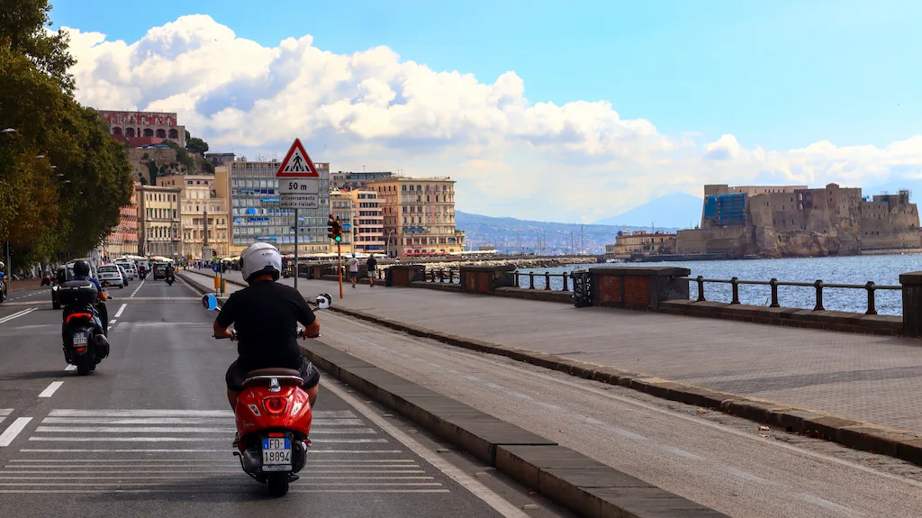 Riding a vespa in Naples Italy