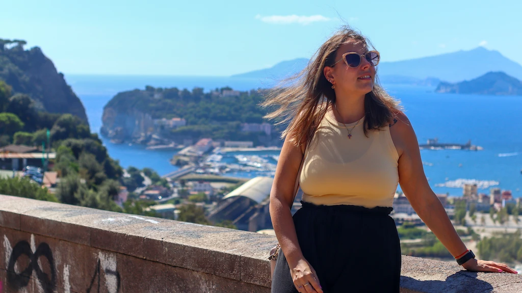 Ale posing on the balcony of the Parco Virgiliano in Naples Posillipo with the background of Nisida island